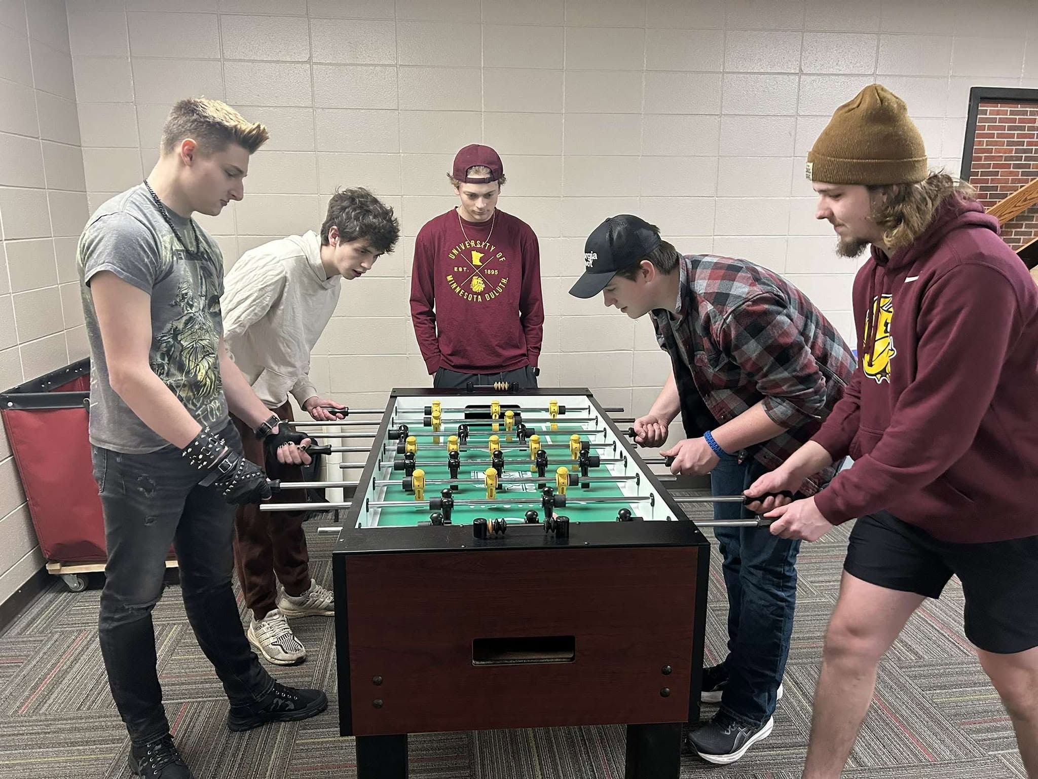 College students playing foosball at their campus club